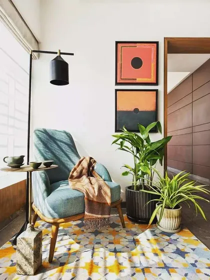 A cozy reading corner is made even better with plants. I helped select these indoor plants and pots to complement the client's decor, adding life and fresh air to their personal relaxation spot.
