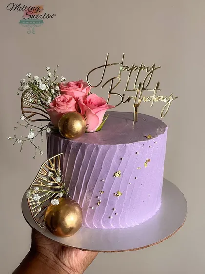 Another look at our purple buttercream cake, held to show its perfect size and beautiful decoration. The client loved it!