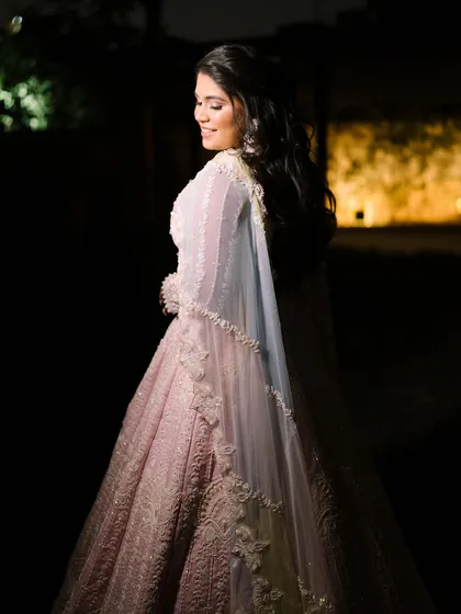 A candid moment of the bride, looking radiant and happy. The makeup is soft and romantic, perfect for an engagement party.