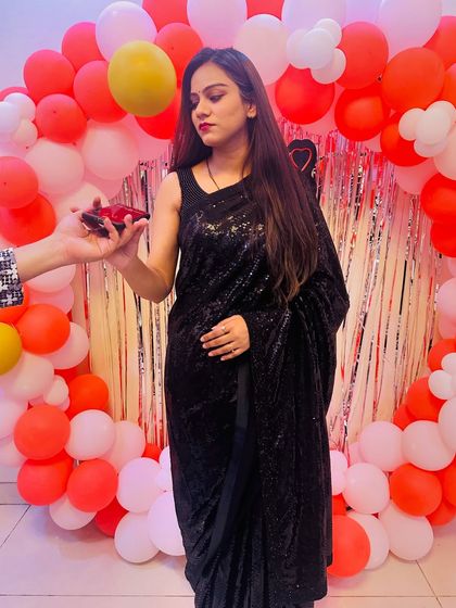 A client looking glamorous in a classic black sequin saree, perfect for a birthday party or cocktail event.