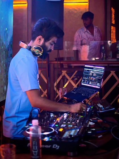 A shot of me working the console at The Fixx Bar. My setup includes professional Pioneer DJ equipment to ensure the best sound quality for every event.
