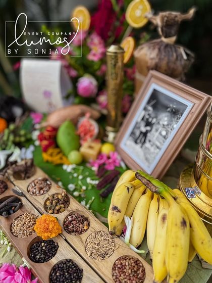 A traditional Navadhanyam (nine grains) display, symbolizing prosperity and blessings, beautifully arranged with fruits and flowers.