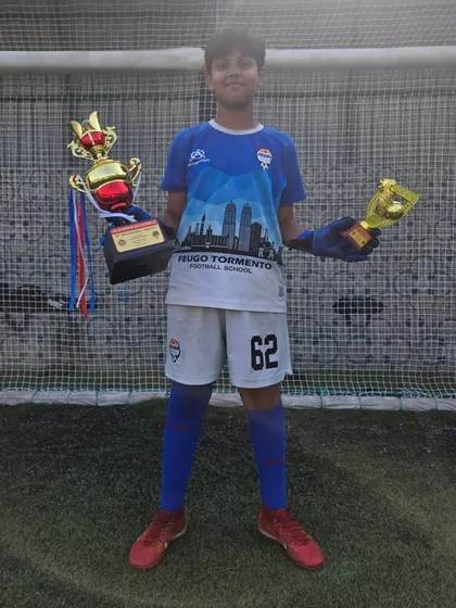 Our U12 goalkeeper with his championship trophy and best goalkeeper award.