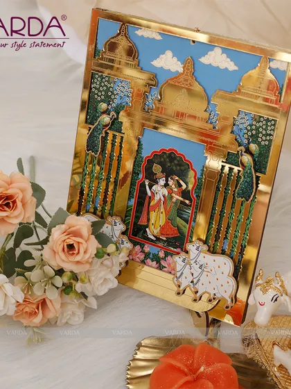 A beautiful Radha Krishna themed wedding invitation featuring a 3D pop-up within a golden archway. The design, inspired by traditional Indian art, captures the divine romance of Radha and Krishna, making it a perfect start to your wedding story.