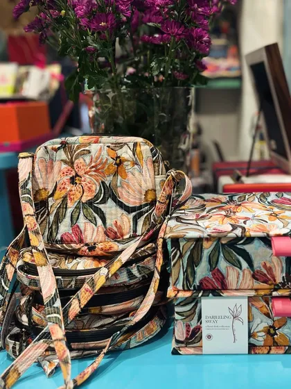 A stack of quilted sling bags and keepsake boxes from the Darjeeling Sway collection. These limited-edition pieces are full of joy and ready for your adventures.