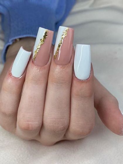 A chic color-blocked design on square nails, with white and nude sections separated by a striking strip of gold foil.
