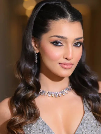 One of our favorite looks of the season. This cocktail glam features a sharp winged liner, shimmering eyelids, and soft waves for a look that is both modern and classic.
