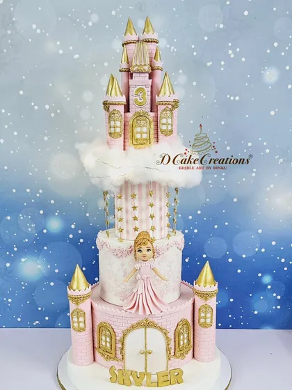 A full shot of the grand four-tier castle cake, complete with hanging stars and a cloud effect, making it a true fairytale creation.