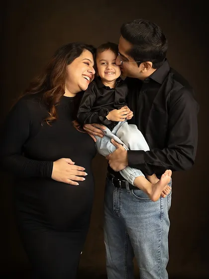 A candid moment of pure joy during a classic studio session. The son's laughter is infectious, creating a memory of genuine happiness.