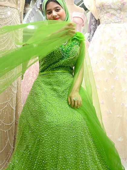 The way this green gown drapes is simply beautiful. The fitted bodice and voluminous skirt create a regal silhouette that is both modest and show-stopping.