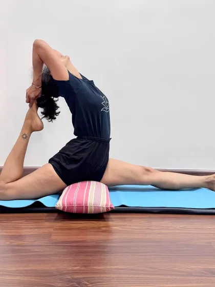 Eka Pada Rajakapotasana (One-Legged King Pigeon Pose) is an advanced backbend that also deeply opens the hips. Using a small pillow for support under the hip makes the pose more stable and allows for a greater focus on the spinal extension.