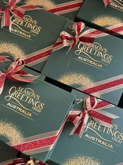 The finished Christmas boxes for the Australian Consulate, all tied up with a festive red and gold ribbon. The gold foil lettering on the green box looks so elegant.