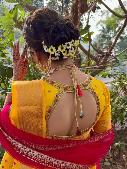 A detailed shot of the bridal bun adorned with fresh flowers, a classic element of the Maharashtrian bridal hairstyle.