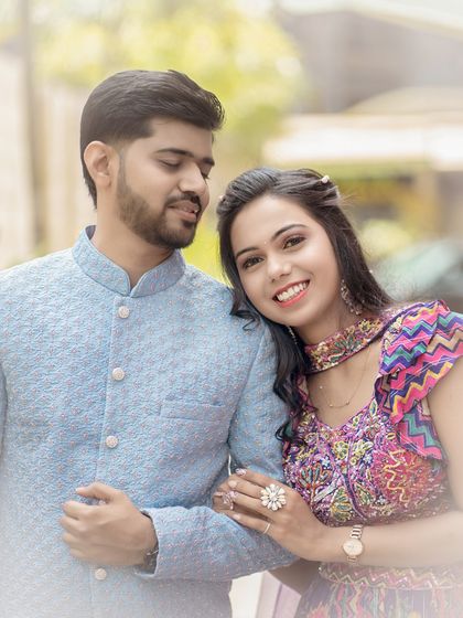 A sweet and gentle moment between the couple. She rests her head on his arm, and her happy smile is a perfect reflection of the love and comfort she feels with him.