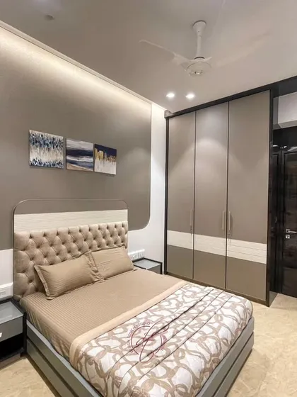 A full view of the bedroom, highlighting the balance between the sleeping area and the functional zones. The soothing color palette and warm lighting create a truly inviting sanctuary.