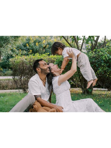 A family playing together on the grass. These sessions are about interaction and connection, creating a space where you can relax and just enjoy being with each other.