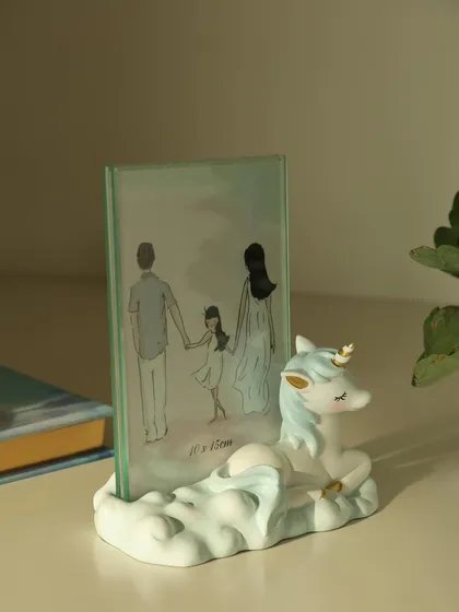 A magical unicorn-themed photo frame, perfect for a child's room. The sleepy unicorn rests on a cloud, creating a dreamy and enchanting home for a special photo.