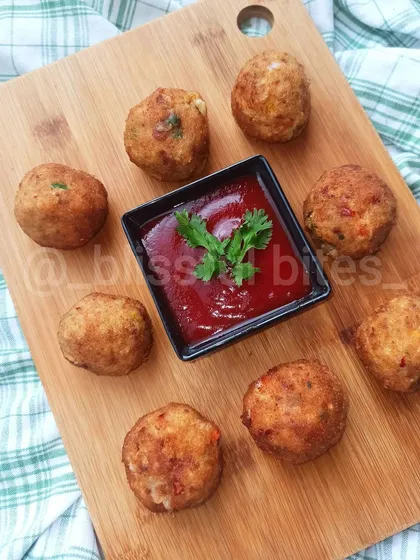 These golden-brown Chicken Cheese Shots are a perfect party starter or tea-time snack. Served hot with a side of ketchup, these bite-sized treats are crispy on the outside and filled with gooey melted cheese and savory chicken.