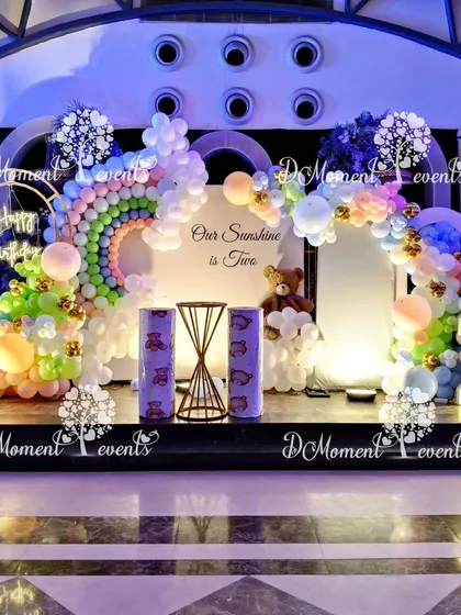 Another view of the "Our Sunshine is Two" stage, showing the beautiful lighting and the full arrangement of balloons and props.