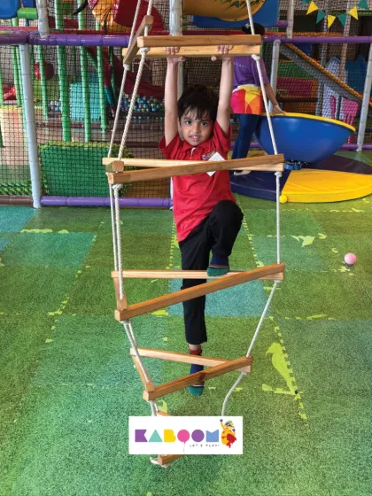 Showing off some serious strength on the rope ladder. It's a great workout and tons of fun.
