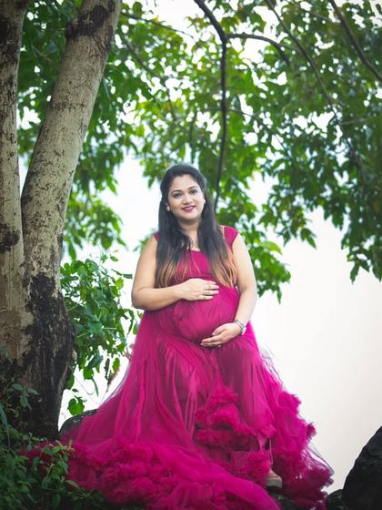 A dramatic portrait in a stunning ruffled magenta gown. The texture and volume of the dress make a beautiful statement against the simple, natural setting.