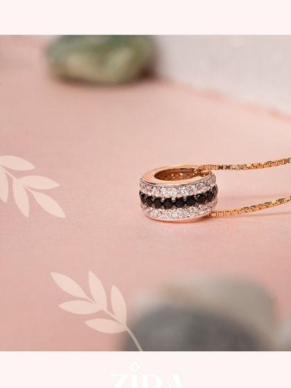 A statement pendant featuring concentric circles of black and white CZ diamonds on a sleek chain.