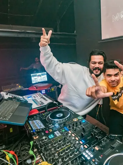 Posing with a fellow artist at the New Year's 2023 party. A moment of celebration behind the decks.