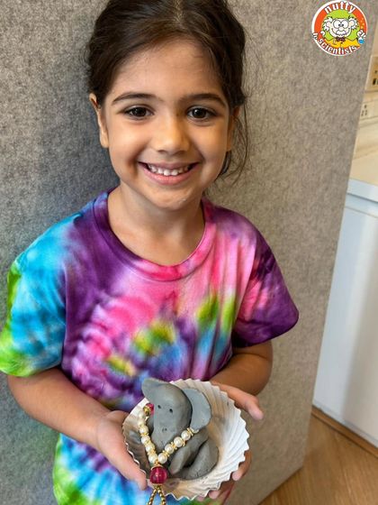 The smile of accomplishment. This young girl is so happy with the eco-friendly Ganesha she created with her own hands.