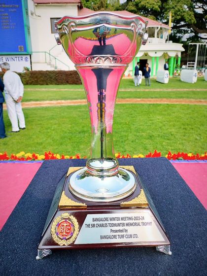 The Sir Charles Todhunter Memorial Trophy, a tall and elegant silver cup.