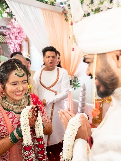 The joy and excitement of the 'varmala' ceremony, with guests cheering for the couple.