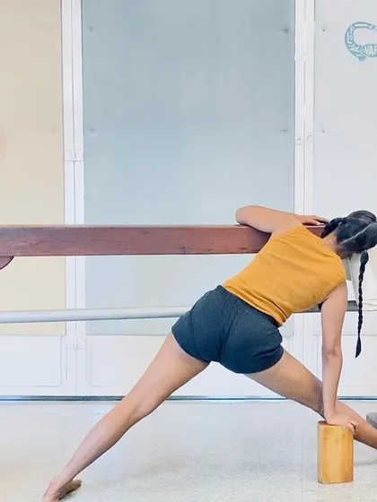 Using a trestle prop in Parsvakonasana (Side Angle Pose) provides support to explore the pose with precision. This allows for a deeper opening in the side body and hips, while ensuring the alignment of the spine and legs remains intact.