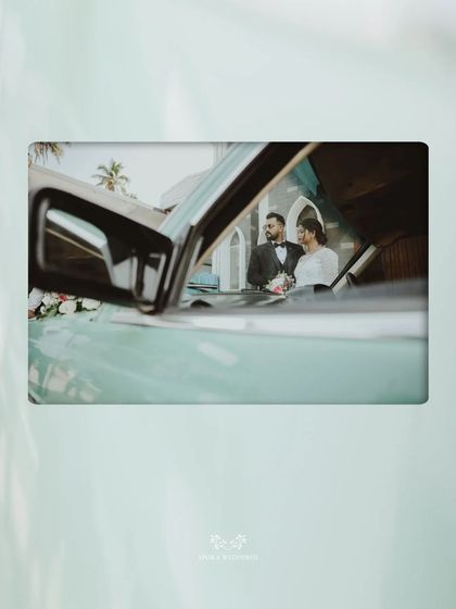 An artistic shot of the couple reflected in the side mirror of their vintage car, a creative and unique wedding memory.