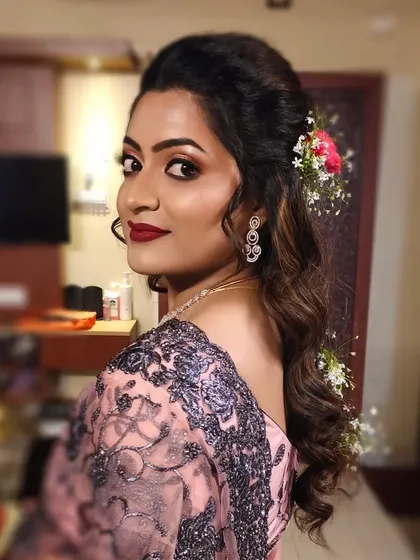 Another angle of the hairstyle, showing the soft curls and floral accessories from the back.