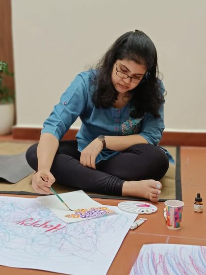 This participant is adding intricate details to her mindful art piece. It's a beautiful process of self-reflection and creative expression.
