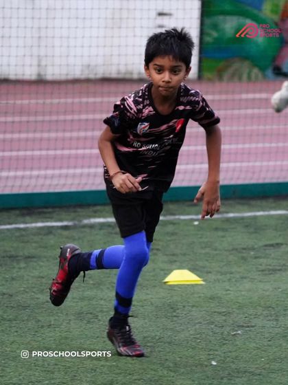 A player works on their running form and agility during a training exercise.