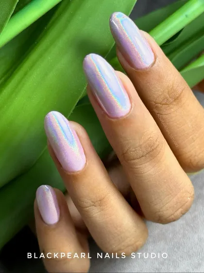 This set shows how a special effect can transform a simple color. I used a holographic chrome powder over a soft lilac gel polish, creating a magical finish that shifts through a rainbow of colors in different lighting.