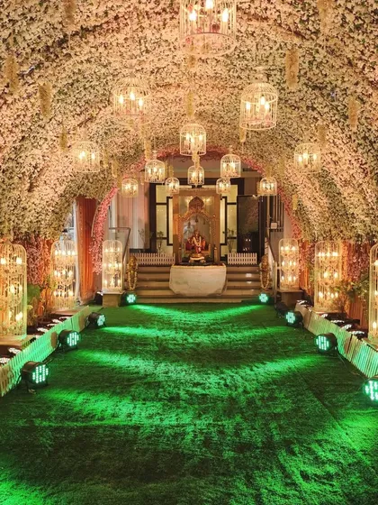 I created this "Blossom Bliss" entrance with a tunnel of faux cherry blossoms and hanging birdcage lanterns. It's a perfect way to welcome guests to a sophisticated evening reception.