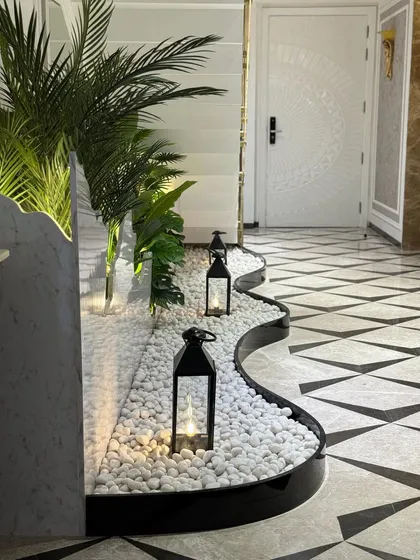 The flowing, organic shape of the planter bed contrasts beautifully with the geometric floor tiles. This design turns a simple walkway into a captivating design feature.