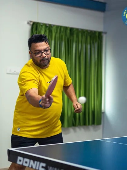 A player returns a shot with a quick backhand. Our tables are always waiting for a challenge, whether you're a beginner or an experienced player.