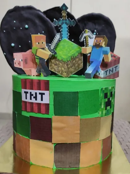 I love bringing your favorite worlds to life, like with this custom Minecraft theme cake. The design features edible block textures and non-edible character toppers to create a centerpiece perfect for any gamer's birthday.
