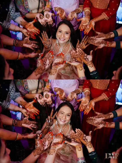 A fun and creative shot of the bride surrounded by the henna-adorned hands of her friends and family. It’s a beautiful symbol of love and sisterhood.