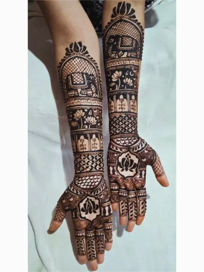 An asymmetrical design where each hand tells a part of the story. One arm highlights a majestic elephant, while both are tied together with matching bands of lotus flowers and geometric patterns.
