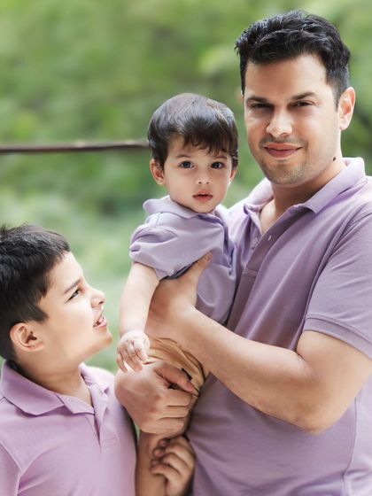 The dynamic between siblings is always changing. Here, the older brother's expression shows the curiosity and love he has for the new addition to the family.