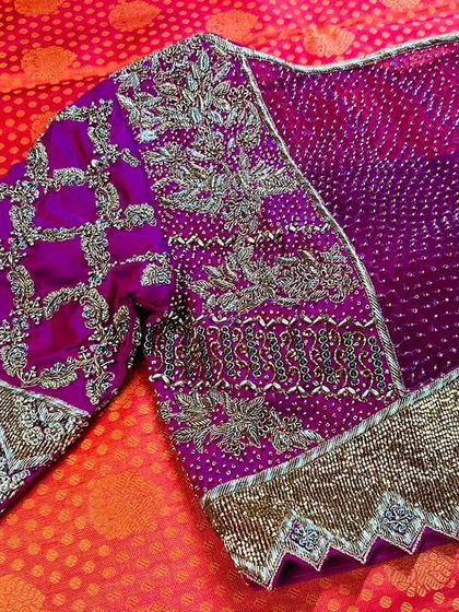 A truly royal creation for a special client. This magenta blouse is a showcase of heavy craftsmanship, featuring intricate zari and beadwork on a traditional bandhani base, with unique scalloped sleeve cuffs for a regal finish.