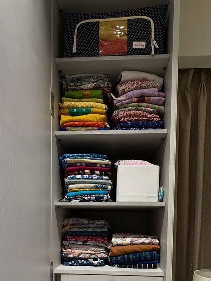Stacking folded clothes can work in a pinch, but we always recommend dividers or bins to maintain order. Here, a clear-front bag on top stores less-used items.