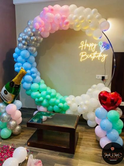 Another pastel balloon ring setup, this time with a champagne bottle and heart balloon for a celebratory touch.