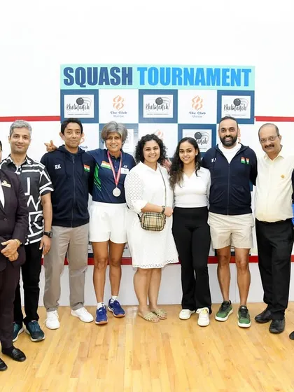The team behind the scenes and the champions on the court. A group photo celebrating a successful squash tournament at The Club, Mumbai.