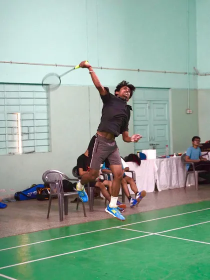 This action shot from a low angle emphasizes the height and power of the player's jump smash.