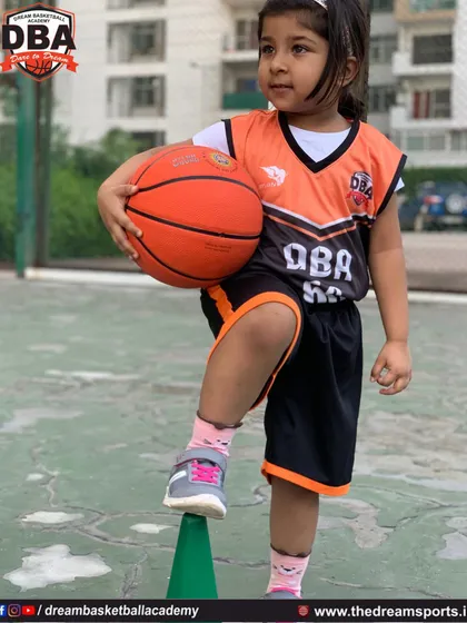 This young athlete is learning balance and coordination by practicing with a cone, a fundamental step in our youth training program.