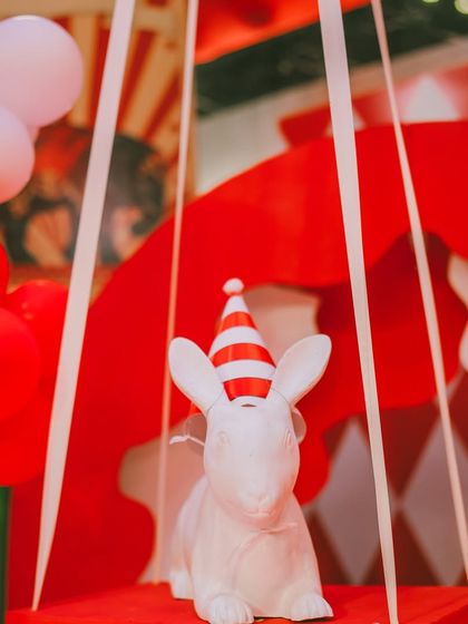Even the smallest props get a festive touch. This white rabbit is ready for the party with its own red and white striped hat, a tiny detail that brings a smile.